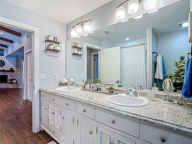 1014 Sylvia Ln, Tampa, FL 33613 - bathroom with double vanity and wood finished floors
