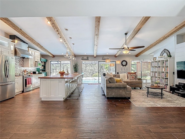 1014 Sylvia Ln, Tampa, FL 33613 - living room featuring dark wood-style flooring, ceiling fan, and beamed ceiling