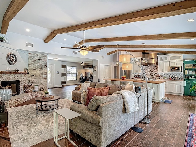 1014 Sylvia Ln, Tampa, FL 33613 - living area featuring dark wood-type flooring, a ceiling fan, recessed lighting, and a fireplace