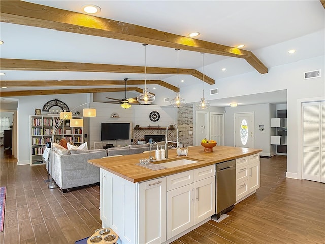 1014 Sylvia Ln, Tampa, FL 33613 - kitchen featuring wood counters, dishwasher, a ceiling fan, a fireplace, and dark wood-type flooring