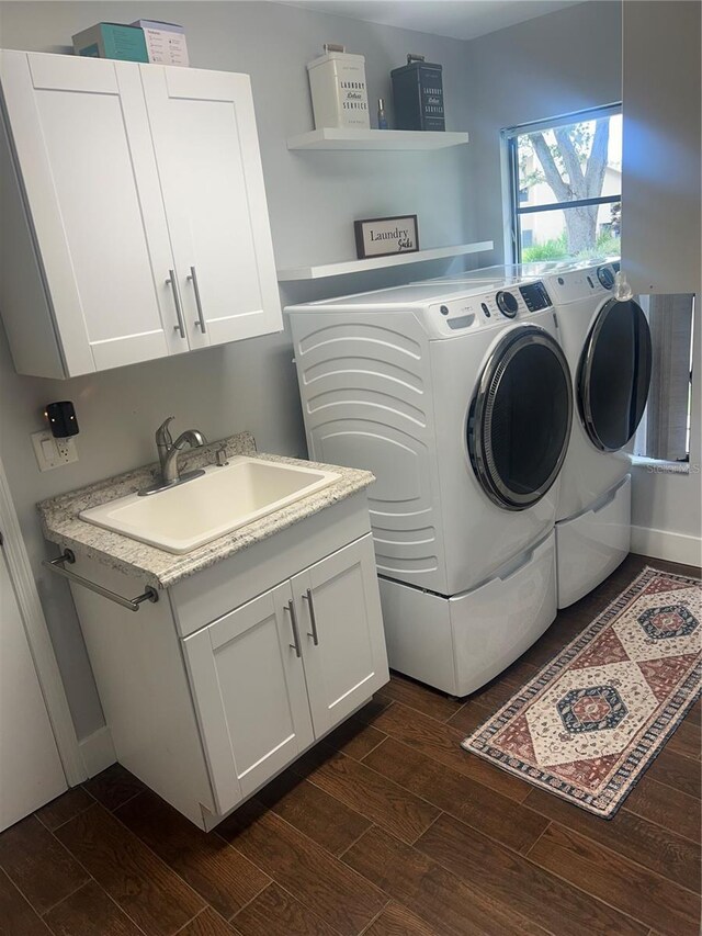 1014 Sylvia Ln, Tampa, FL 33613 - laundry area with washing machine and dryer, dark wood-style floors, and cabinet space