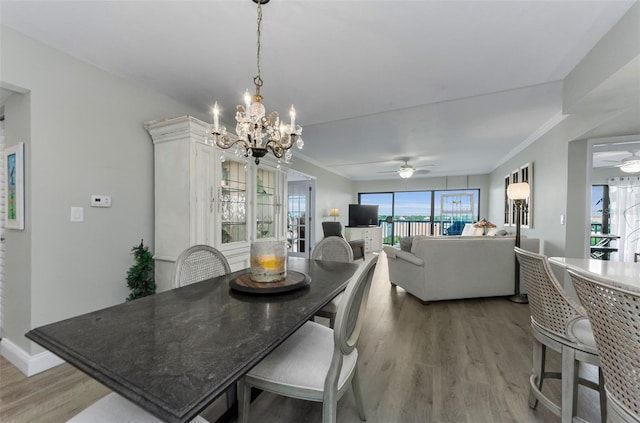 2700 Bayshore Blvd Unit 11405, Dunedin, FL 34698 - dining room featuring plenty of natural light, light wood-style flooring, a chandelier, crown molding, and ceiling fan