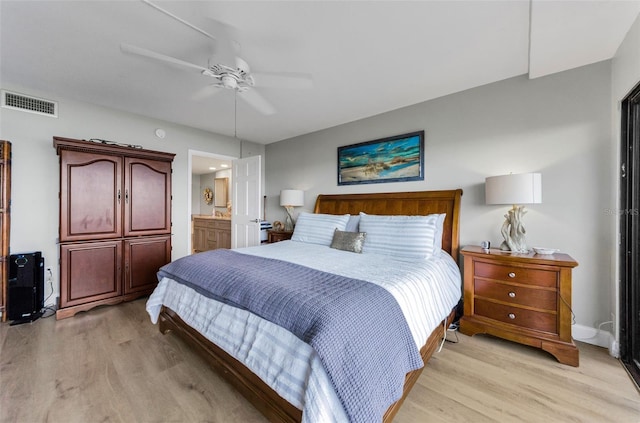 2700 Bayshore Blvd Unit 11405, Dunedin, FL 34698 - bedroom featuring light wood-style flooring, ceiling fan, connected bathroom, and baseboards