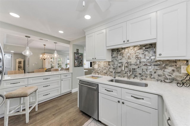 2700 Bayshore Blvd Unit 11405, Dunedin, FL 34698 - kitchen with dishwasher, stacked washer and clothes dryer, white cabinetry, light countertops, and wood finished floors