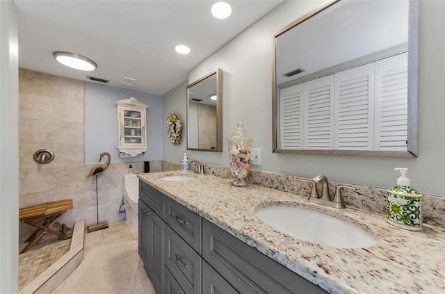 2700 Bayshore Blvd Unit 11405, Dunedin, FL 34698 - full bath with double vanity, tile walls, tiled shower, tile patterned floors, and recessed lighting