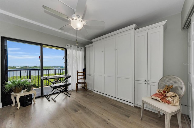 2700 Bayshore Blvd Unit 11405, Dunedin, FL 34698 - living area with light wood-type flooring, a water view, and a ceiling fan