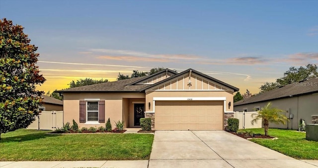 12428 Chaya Ct, Spring Hill, FL 34610 - view of front of house featuring an attached garage, driveway, board and batten siding, stucco siding, and stone siding