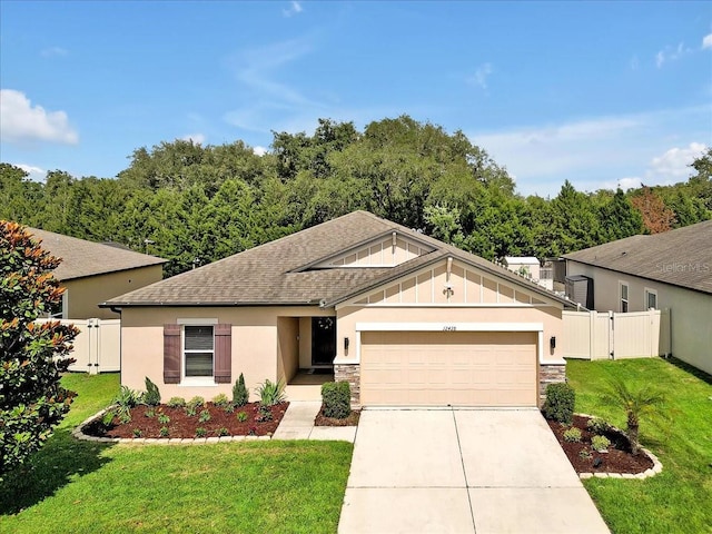 12428 Chaya Ct, Spring Hill, FL 34610 - view of front of property featuring a garage, concrete driveway, roof with shingles, a gate, and stone siding