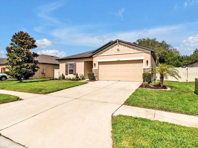 12428 Chaya Ct, Spring Hill, FL 34610 - view of front of house with a garage, concrete driveway, stone siding, board and batten siding, and stucco siding