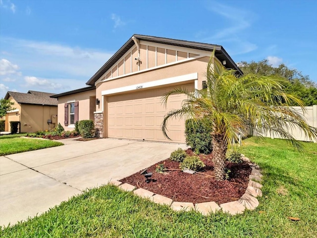 12428 Chaya Ct, Spring Hill, FL 34610 - view of front of property with a garage, driveway, board and batten siding, a front yard, and stucco siding