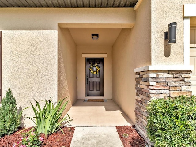 12428 Chaya Ct, Spring Hill, FL 34610 - doorway to property with stucco siding and stone siding