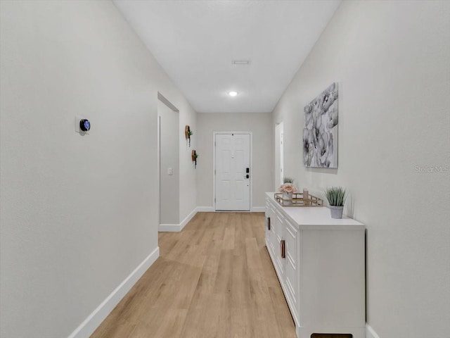 12428 Chaya Ct, Spring Hill, FL 34610 - doorway to outside with baseboards and light wood-style flooring