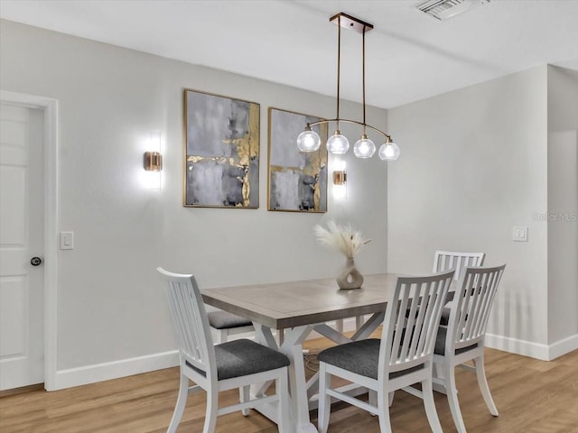 12428 Chaya Ct, Spring Hill, FL 34610 - dining area with baseboards and light wood-style flooring