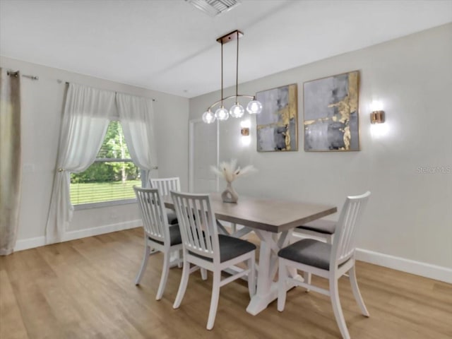 12428 Chaya Ct, Spring Hill, FL 34610 - dining room featuring baseboards and light wood-style floors