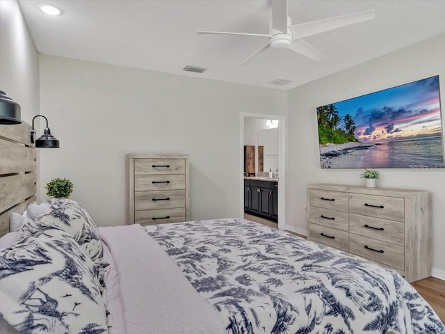 12428 Chaya Ct, Spring Hill, FL 34610 - bedroom with wood finished floors, a ceiling fan, ensuite bath, and recessed lighting