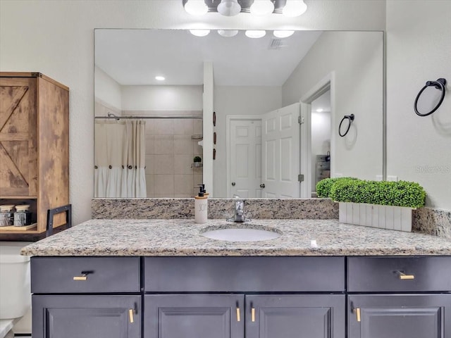 12428 Chaya Ct, Spring Hill, FL 34610 - bathroom featuring toilet, vanity, and a tile shower