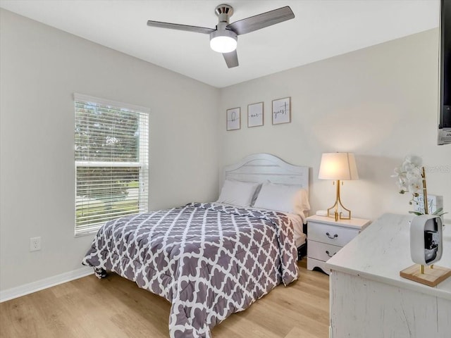 12428 Chaya Ct, Spring Hill, FL 34610 - bedroom with light wood-style floors, baseboards, and ceiling fan