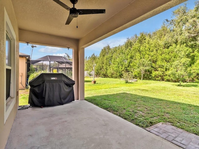 12428 Chaya Ct, Spring Hill, FL 34610 - view of patio featuring ceiling fan, glass enclosure, and a wooded view