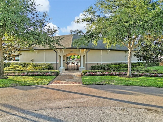 12428 Chaya Ct, Spring Hill, FL 34610 - view of front of house with a gate and stucco siding