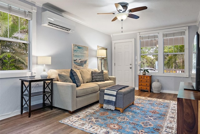 1211 14th St N, Saint Petersburg, FL 33705 - living room featuring a wall mounted AC, ceiling fan, ornamental molding, wood finished floors, and baseboards