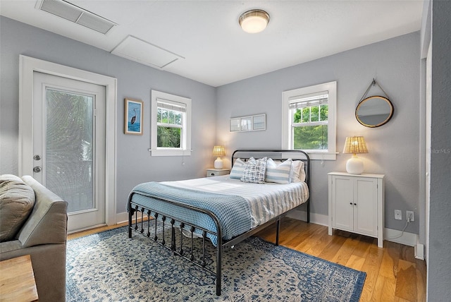 1211 14th St N, Saint Petersburg, FL 33705 - bedroom with multiple windows, light wood-style floors, baseboards, and attic access