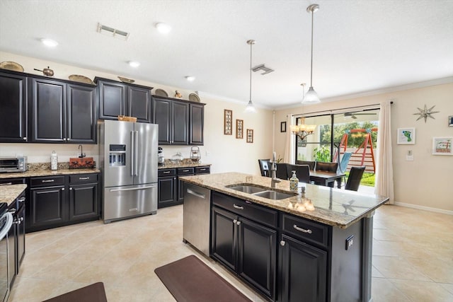 11802 Twilight Darner Pl, Riverview, FL 33569 - kitchen with appliances with stainless steel finishes, a sink, dark cabinets, ornamental molding, and a center island with sink
