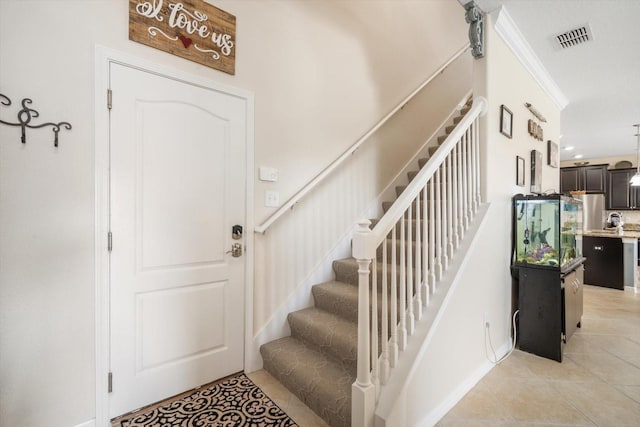 11802 Twilight Darner Pl, Riverview, FL 33569 - entryway with light tile patterned flooring, stairs, and ornamental molding