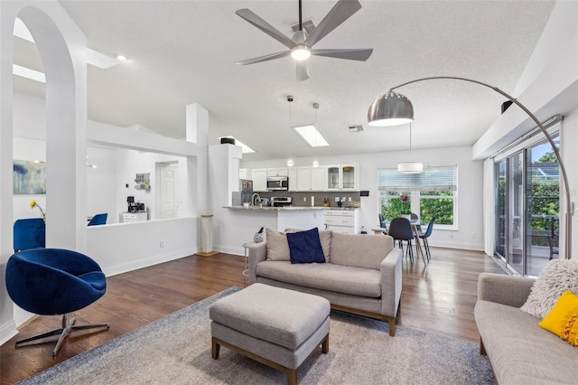 892 Crestridge Cir, Tarpon Springs, FL 34688 - living area featuring wood finished floors, baseboards, a ceiling fan, and lofted ceiling