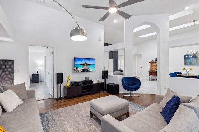 892 Crestridge Cir, Tarpon Springs, FL 34688 - living area featuring wood finished floors, high vaulted ceiling, a ceiling fan, arched walkways, and recessed lighting