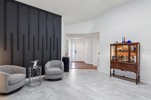892 Crestridge Cir, Tarpon Springs, FL 34688 - sitting room featuring lofted ceiling, baseboards, and light wood-type flooring
