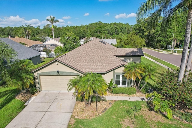 892 Crestridge Cir, Tarpon Springs, FL 34688 - view of front of home with a shingled roof, a garage, concrete driveway, stucco siding, and a front yard