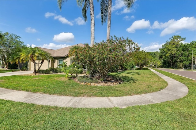 892 Crestridge Cir, Tarpon Springs, FL 34688 - view of front facade with concrete driveway, a front lawn, an attached garage, and stucco siding