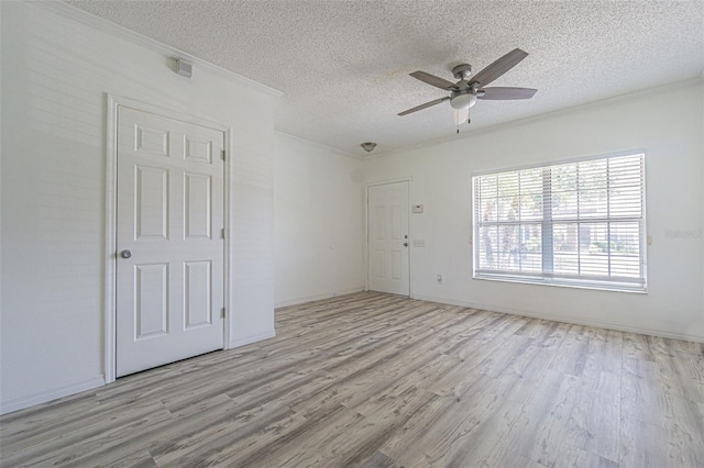 6229 Bayside Key Dr, Tampa, FL 33615 - spare room featuring wood finished floors, a ceiling fan, a textured ceiling, and crown molding