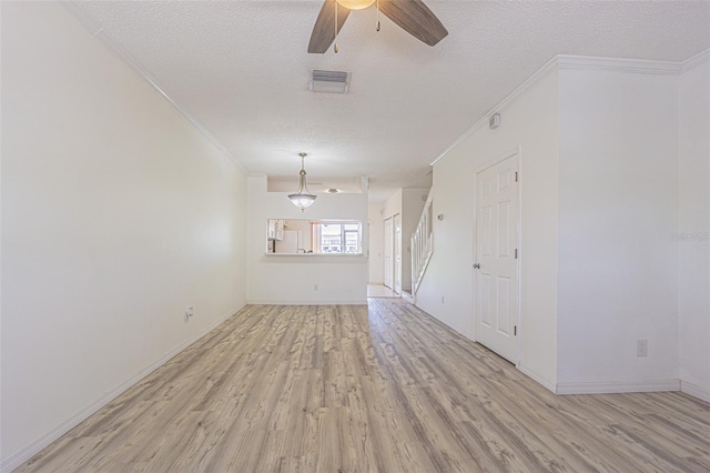 6229 Bayside Key Dr, Tampa, FL 33615 - unfurnished living room with light wood-style floors, crown molding, a ceiling fan, a textured ceiling, and baseboards