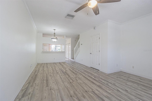 6229 Bayside Key Dr, Tampa, FL 33615 - unfurnished living room with crown molding, light wood-style floors, ceiling fan, a textured ceiling, and stairs