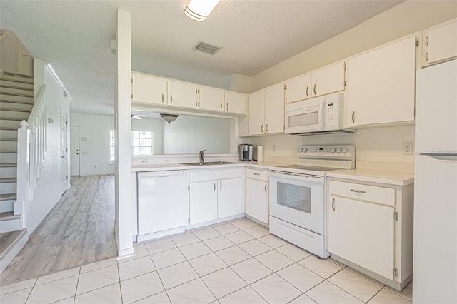 6229 Bayside Key Dr, Tampa, FL 33615 - kitchen with white appliances, a sink, light countertops, and white cabinets