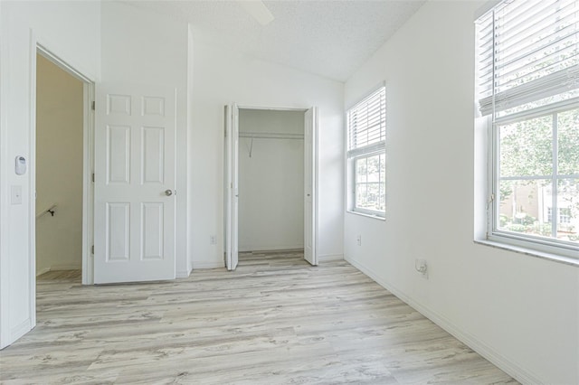 6229 Bayside Key Dr, Tampa, FL 33615 - unfurnished bedroom featuring light wood-style flooring, lofted ceiling, a closet, baseboards, and a ceiling fan