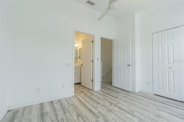 6229 Bayside Key Dr, Tampa, FL 33615 - unfurnished bedroom with light wood-style flooring, a closet, baseboards, ceiling fan, and connected bathroom