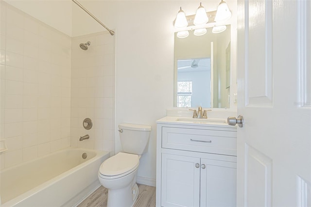 6229 Bayside Key Dr, Tampa, FL 33615 - full bath with toilet, vanity, bathing tub / shower combination, wood finished floors, and baseboards