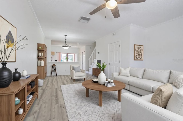 6229 Bayside Key Dr, Tampa, FL 33615 - living area featuring ceiling fan, stairway, light wood-type flooring, and crown molding