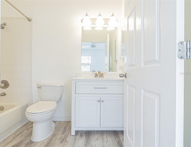 6229 Bayside Key Dr, Tampa, FL 33615 - bathroom with toilet, vanity, wood finished floors, bathtub / shower combination, and baseboards