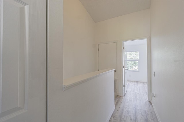 6229 Bayside Key Dr, Tampa, FL 33615 - corridor with light wood-style flooring, baseboards, and an upstairs landing
