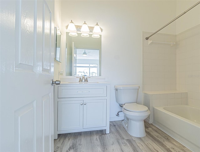 6229 Bayside Key Dr, Tampa, FL 33615 - bathroom with toilet,  shower combination, vanity, and wood finished floors