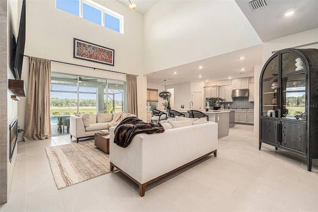 33774 Castaway Loop, Wesley Chapel, FL 33543 - living area with plenty of natural light, a towering ceiling, a ceiling fan, and light tile patterned floors