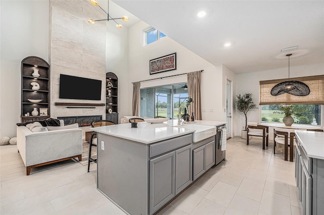 33774 Castaway Loop, Wesley Chapel, FL 33543 - kitchen featuring gray cabinetry, a sink, healthy amount of natural light, light countertops, and a high ceiling