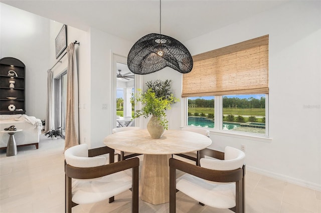33774 Castaway Loop, Wesley Chapel, FL 33543 - dining space with healthy amount of natural light, a ceiling fan, and baseboards