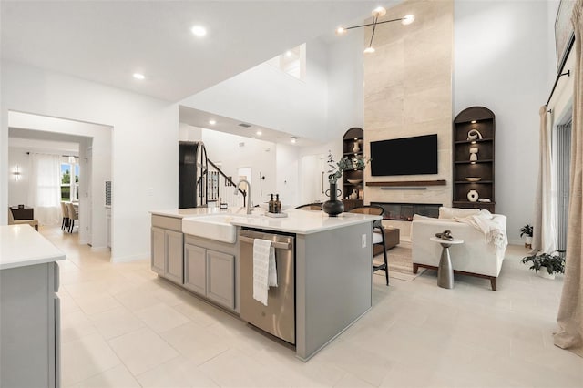 33774 Castaway Loop, Wesley Chapel, FL 33543 - kitchen with gray cabinetry, a sink, dishwasher, a center island with sink, and light countertops