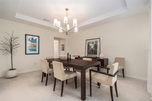 33774 Castaway Loop, Wesley Chapel, FL 33543 - dining area featuring a tray ceiling, a chandelier, and baseboards