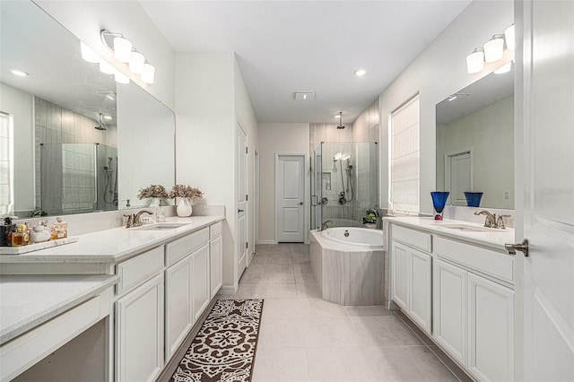 33774 Castaway Loop, Wesley Chapel, FL 33543 - full bathroom with a shower stall, two vanities, tile patterned flooring, a bath, and recessed lighting