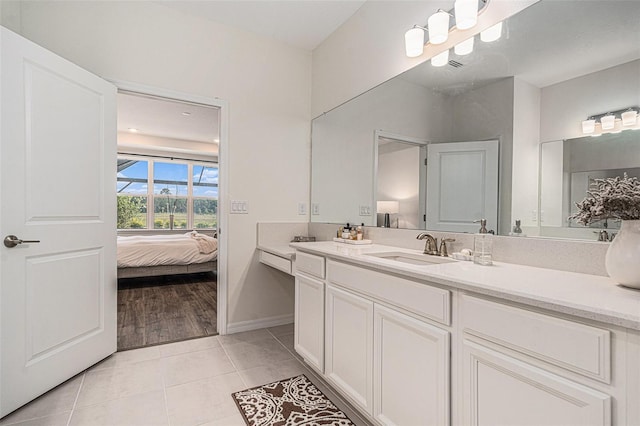 33774 Castaway Loop, Wesley Chapel, FL 33543 - bathroom featuring ensuite bathroom, vanity, tile patterned flooring, and baseboards